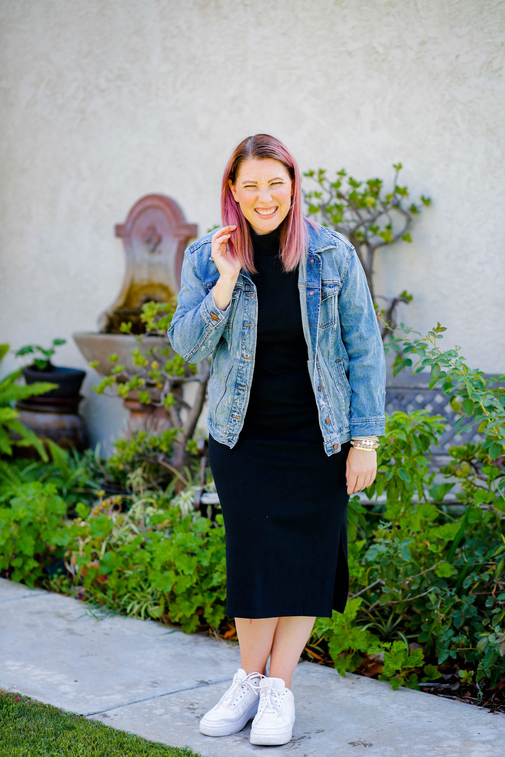 Stunning young brunette woman wearing denim jacket, black turtleneck  fashion headset leaning against brick wall Stock Photo | Adobe Stock